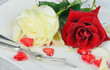 Romantic place setting with darkred and white rose and hearts