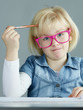 Blonde girl with pink glasses thinking about difficult exercises