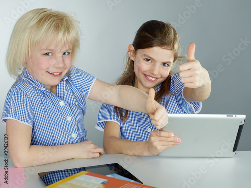 Photo: Girls shows thumbs up for learning by mobile device Girls shows thumbs up for learning by mobile device