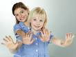 Cute girlfriends with painted fingers having fun