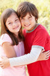 Portrait hispanic brother and sister outdoors
