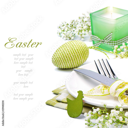 Photo: Easter table setting with candle and flowers Easter table setting with candle and flowers