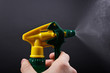 spray bottle - lighted while spraying on dark background