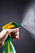 spray bottle - lighted while spraying on dark background