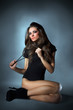 Photo: Young slim glamour lady with long hairs dressed in black combi d Young slim glamour lady with long hairs dressed in black combi d