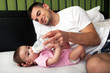 Portrait of father feeding daughter