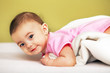 Happy Baby lying on white towel
