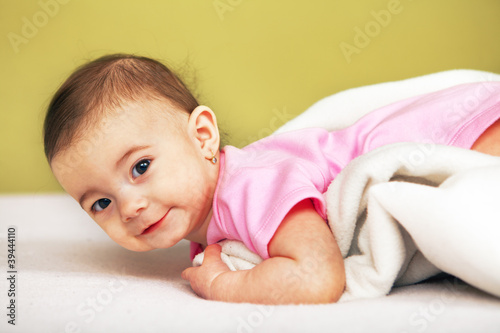Photo: Happy Baby lying on white towel Happy Baby lying on white towel
