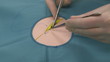Surgeon  exercising stitching, starting a double stitch