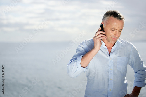 Photo: Man on the phone outdoors Man on the phone outdoors