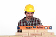Mason checking level of a brick wall