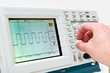 Engineer Operating a Digital Oscilloscope