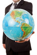 Business man holding a globe in his hand, isolated on white Business man holding a globe in his hand, isolated on white