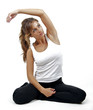 Photo: A beautiful woman sits and stretches before exercise. A beautiful woman sits and stretches before exercise.