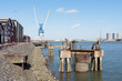 Quayside with factory buildings and crane in the harbor of Rotte
