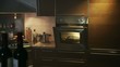 domestic kitchen with chicken in oven