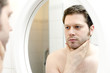 Man looks at his beard and thought about shaving