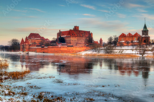 Photo: Teutonic castle in Malbork with frozen Nogat river, Poland Teutonic castle in Malbork with frozen Nogat river, Poland