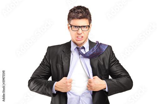 Photo: Superhero businessman opening blue shirt Superhero businessman opening blue shirt