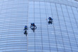 Workers washing windows in the office building