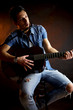 Serious male model with guitar intense
