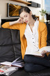 the girl reading a book, her elbow is resting on the back of th the girl reading a book, her elbow is resting on the back of th