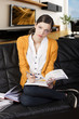 the girl reading a book and looks in to the lens the girl reading a book and looks in to the lens