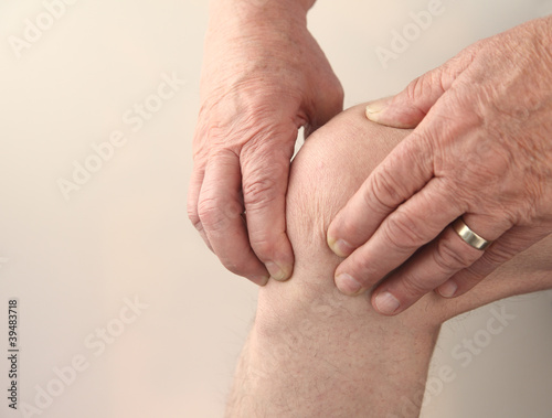 Photo: man tends to his sore knee man tends to his sore knee