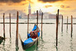 Gondola at sunset pier near in Venice, Italy Gondola at sunset pier near in Venice, Italy
