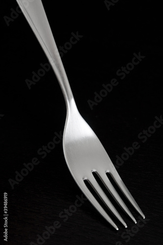 Photo: Silver fork on dark background Silver fork on dark background