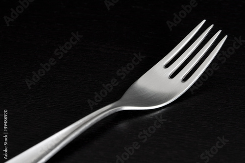 Photo: Silver fork on black background Silver fork on black background