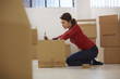 Caucasian woman moving to new apartment with boxes