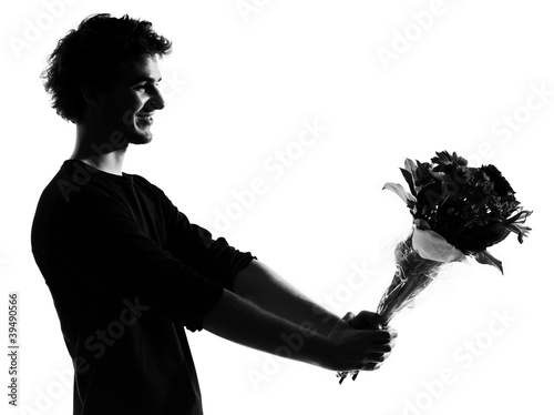 Photo: young man silhouette offering flowers bouquet young man silhouette offering flowers bouquet