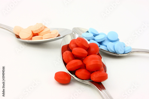 Photo: Colorful Pills In Three Spoons Colorful Pills In Three Spoons