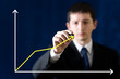 Businessman drawing chart with marker over blue background
