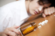 睡眠薬を飲んで倒れるビジネスマン