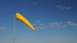 Orange windsock with blue sky background