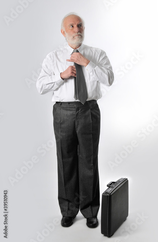 Photo: a man fixes his tie a man fixes his tie