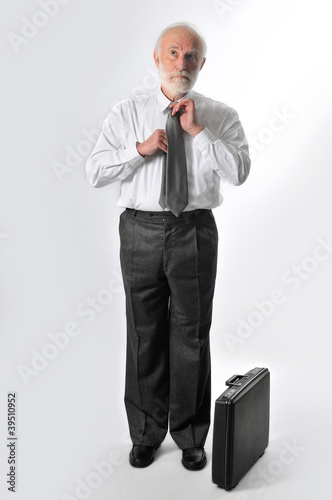 Photo: a man fixes his tie a man fixes his tie