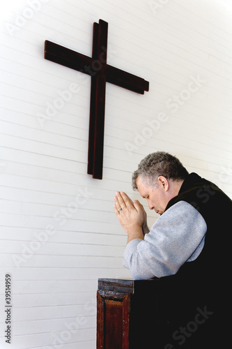 Photo: Man Praying at Wooden Cross Man Praying at Wooden Cross