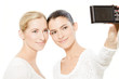 Foto: two young women taking pictures two young women taking pictures