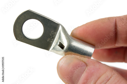 Photo: Crimp terminal ring for heavy electric cable in handd on white Crimp terminal ring for heavy electric cable in handd on white