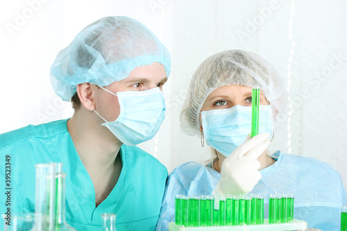 Photo: two scientists working in chemistry laboratory. two scientists working in chemistry laboratory.
