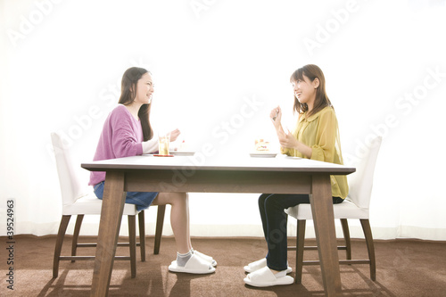 Foto: ダイニングでケーキを食べる女性2人 ダイニングでケーキを食べる女性2人