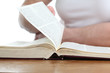 Man Turning The Page Of The Bi...