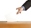 Hand putting a voting ballot in a slot of box isolated