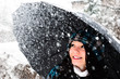 Photo: Young woman with umbrella in a blizzard Young woman with umbrella in a blizzard