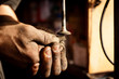 Hands of a worker polishing metal