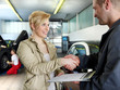 Photo: Female customer and mechanic shaking hands for good deal Female customer and mechanic shaking hands for good deal