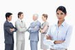 Close-up of a multicultural business team talking and a serious woman in foreground